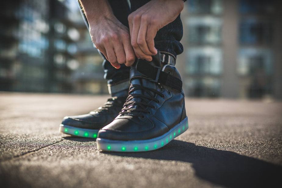 Black LED High Tops with green lighted soles, laces, and buckle closure